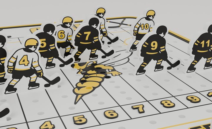 Close-up of the black and white hockey player pieces with gold numbers